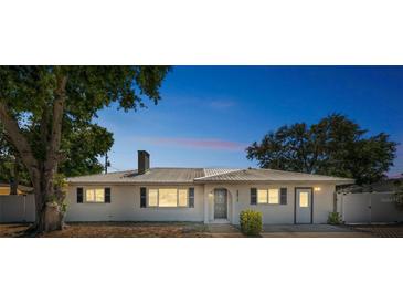 Charming single-story home with a well-maintained lawn and a metal roof at 5817 26Th W St, Bradenton, FL 34207