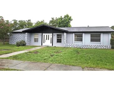 Charming single story home with a stone accent wall and well-maintained lawn at 2202 Whitney Pl, Valrico, FL 33594