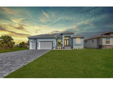 Beautiful single-story home with a well-manicured lawn, double garage, and a neatly paved driveway at 261 Rotonda S Blvd, Rotonda West, FL 33947