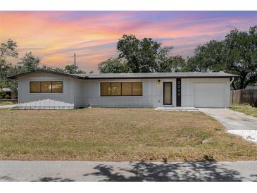 Charming single-story home with a well-maintained lawn and an attached single car garage at 2239 Worrington St, Sarasota, FL 34231