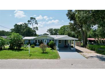 Charming single-story home with a covered carport and well-maintained front lawn at 5213 Keene Dr, Plant City, FL 33566