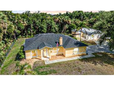 Charming single-story home with a well-maintained front yard and mature trees at 5404 Carso Ter, North Port, FL 34286