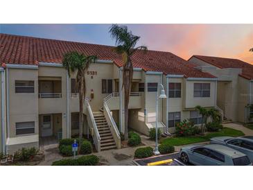 Multi-unit building with red tile roof, palm trees, and parking area, providing convenient access to homes at 6131 Bahia Del Mar Blvd # 139, St Petersburg, FL 33715