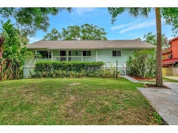 Charming single-story home featuring lush landscaping and a welcoming front porch in a serene setting at 9503 Alice Ln, Riverview, FL 33578