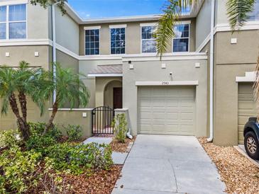 Attractive townhouse featuring a private courtyard with gate, and a one car garage at 2943 Willowleaf Ln, Wesley Chapel, FL 33544