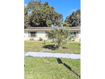 Charming single story home with a well manicured lawn and sidewalk at 1970 Mckinley St, Clearwater, FL 33765