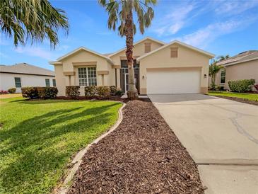 Charming single-story home with a well-manicured lawn and a spacious two-car garage at 5154 51St W Ln, Bradenton, FL 34210