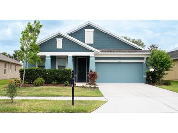 Charming single-Gathering home with a well-maintained lawn and a two-car garage at 32618 Rapids Loop, Wesley Chapel, FL 33545
