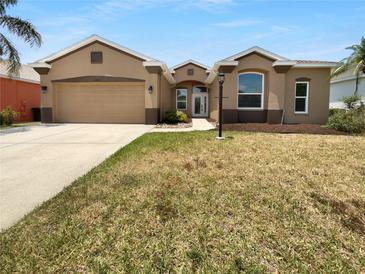 Charming single-story home boasts a well-manicured lawn, attached garage, and inviting curb appeal at 6370 Sturbridge Ct, Sarasota, FL 34238