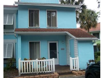 Charming blue townhouse with a brown roof and a welcoming white-picketed porch at 3585 41St S Way # D, St Petersburg, FL 33711