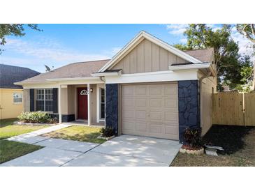 Charming single-Gathering home featuring a stone accented garage and a well-manicured front lawn at 1904 Crown Park Dr, Valrico, FL 33594