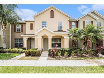 Charming townhome featuring manicured landscaping and a welcoming covered entrance at 14174 Oakham St, Tampa, FL 33626