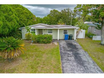 Charming single-story home featuring a well-maintained lawn and driveway at 5651 Kelly N Dr, St Petersburg, FL 33703