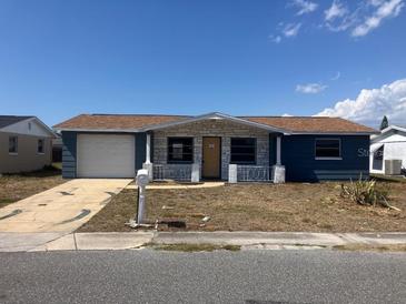 Charming single-story home featuring a front yard, a garage, and a welcoming entrance at 3347 Roxbury Dr, Holiday, FL 34691