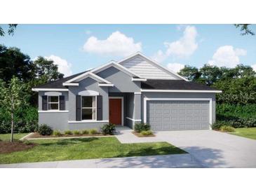 Charming single-story home featuring a two-car garage, neutral gray paint, and a well-manicured lawn at 2803 Sulstone Dr, Punta Gorda, FL 33983