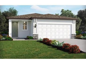 Charming single-story home with a two-car garage, well-manicured lawn, and beautiful landscaping at 14115 Crutchfield Ct, Parrish, FL 34219
