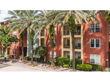 A view of the exterior showing multi-story building with balconies and mature palm trees at 2411 W Horatio St # 537, Tampa, FL 33609