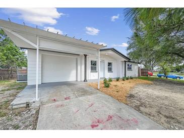 Charming single-story home featuring a driveway with carport and manicured landscaping enhancing its curb appeal at 4119 Beacon Square Dr, Holiday, FL 34691