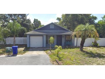 Charming single-story home featuring a classic gable roof and a cozy front porch bench at 3607 Johnson Ct, Palm Harbor, FL 34684