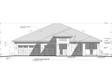 Sand finish stucco exterior home elevation with shingle roof and garage at 2116 Rio De Janeiro Ave, Punta Gorda, FL 33983