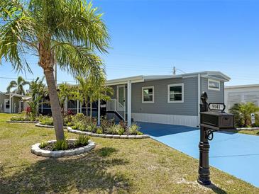 Charming single-story home featuring a well-manicured lawn, tasteful landscaping, and a freshly painted exterior at 5141 Oakland Hills Ave, Sarasota, FL 34234