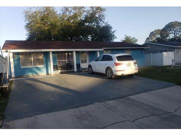 Charming single-story home with a well-maintained lawn and a private driveway at 6718 Runningwoods Dr, Tampa, FL 33634