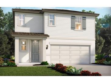 Charming two-story home featuring a gray door, white siding, and an attached two-car garage at 1855 Brekey Way, Zephyrhills, FL 33541
