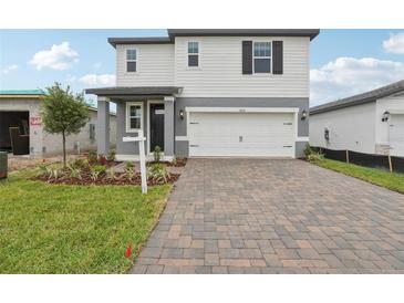 Charming two-story home with a two-car garage and a beautifully paved driveway at 1855 Brekey Way, Zephyrhills, FL 33541