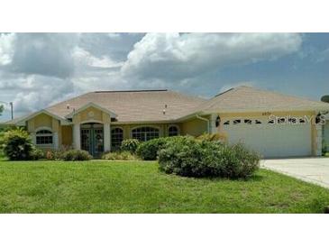 Charming single-story home with well-maintained lawn and attached two-car garage at 4875 Hansard Ave, North Port, FL 34286