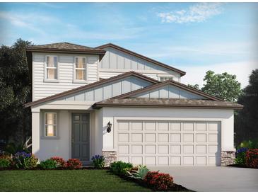 Charming two-story home features a large garage, neutral paint, stone accents, manicured lawn, and beautiful landscaping at 3921 Radiant Mountain Dr, Plant City, FL 33565