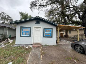 Charming single-story home featuring a covered parking area and a fresh, newly painted exterior with classic curb appeal at 8612 N Alaska St, Tampa, FL 33604