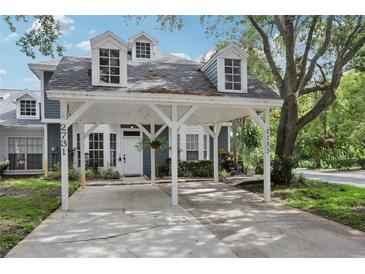 Two story home with a covered parking area and well manicured landscaping at 2731 Penzance St, Palm Harbor, FL 34684