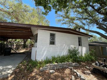 An exterior view of a home with a brick facade and a covered carport area at 432 2Nd Ne Ave, Largo, FL 33770