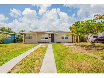 Charming single story home featuring a well-maintained lawn and long driveway at 1020 58Th N Ave, St Petersburg, FL 33703