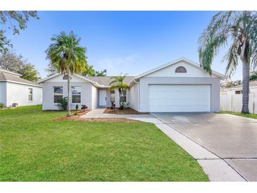 Charming single-story home featuring a two-car garage, well-maintained lawn, and beautiful palm trees at 11212 3Rd E Ave, Bradenton, FL 34212