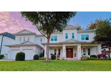 Stunning two-story white home boasts a manicured lawn and charming front porch at 4309 W Beachway Dr, Tampa, FL 33609