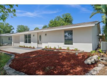 Charming single-story home featuring a well-manicured front yard with tasteful landscaping at 2126 Hanby St, Port Charlotte, FL 33952