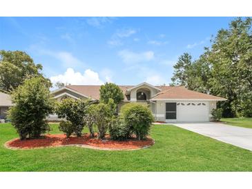 Charming single-Gathering home featuring a well-manicured lawn and two-car garage at 4266 Candler Ave, Spring Hill, FL 34609