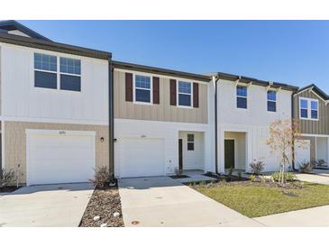 Charming townhomes feature attached garages, well-manicured lawns and inviting exteriors at 6166 Daerr Ridge St, Zephyrhills, FL 33542