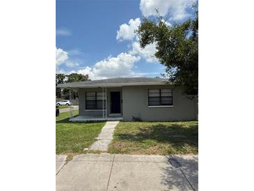 Charming single-story home featuring a covered porch, well-maintained lawn, and neat landscaping at 845 18Th S Ave, St Petersburg, FL 33705