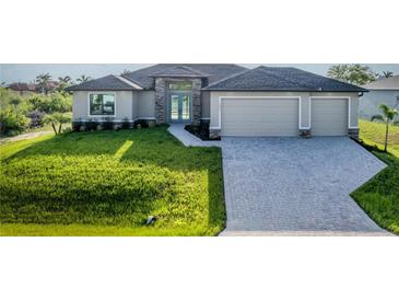 Charming single-story home features lush front yard, paved driveway, and a welcoming entrance at 9257 King Hill St, Port Charlotte, FL 33981