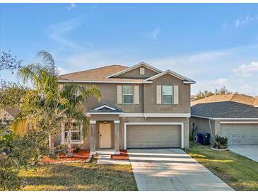 Charming two-story home boasts a well-maintained lawn and a two-car garage at 8506 Hunters Fork Loop, Ruskin, FL 33573