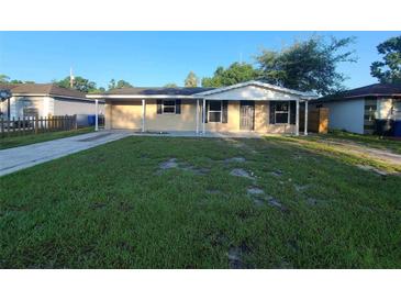 Charming single-story home with a well-maintained lawn and a covered front porch at 3217 Deerfield Dr, Tampa, FL 33619