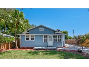 Charming home featuring a well-manicured lawn, palm tree, and a light blue exterior paint at 6020 Illinois Ave, New Port Richey, FL 34653