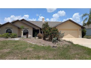 Charming single-story home featuring a well-maintained yard and attached two-car garage in a lovely neighborhood at 141 Angol St, Punta Gorda, FL 33983