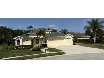 Charming home with a well-manicured lawn, lush landscaping, and a spacious three-car garage at 10937 Bluestem Cir, Lakewood Ranch, FL 34202