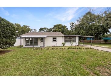 Charming single-story home with a covered front porch and carport at 103 4Th Nw Ave, Lutz, FL 33548