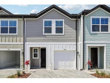 Charming two-story townhome with a one-car garage and neutral gray siding at 7292 Deer Valley Circle, Tampa, FL 33635