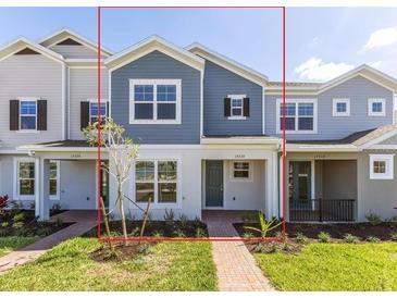 Attractive townhome with blue and gray exterior, covered porch, and well-maintained landscaping at 17330 Alderwood Ln, Punta Gorda, FL 33982