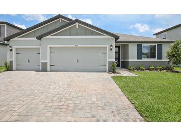 Charming single-Gathering home with a well-manicured lawn and an inviting two-car garage at 1806 Draughton Dr, Zephyrhills, FL 33541